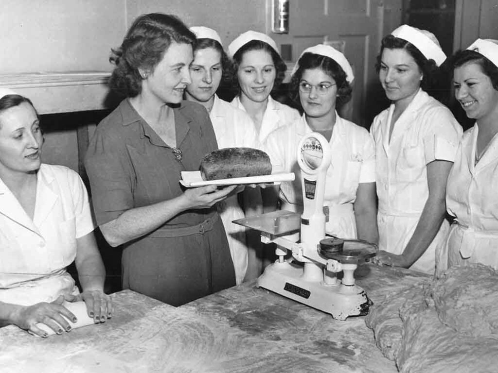 Margaret holding her 100 millionth loaf of bread