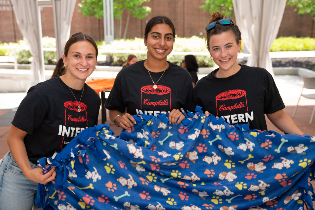 interns holding blanket