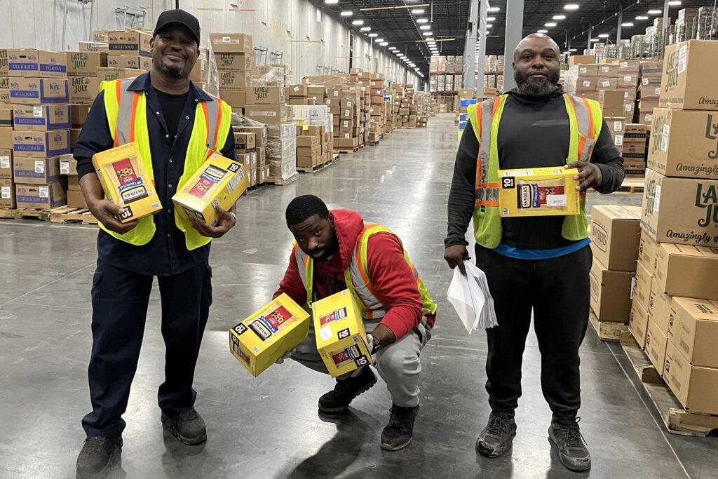 employees holding pretzels at our charlotte mixing center