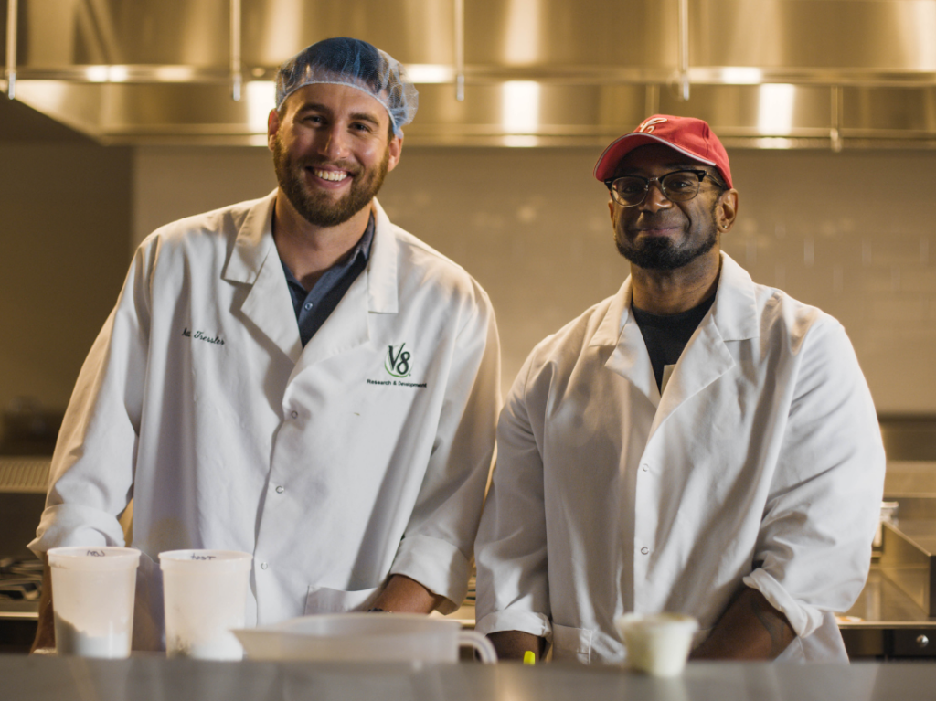 R&D employees smiling in kitchen